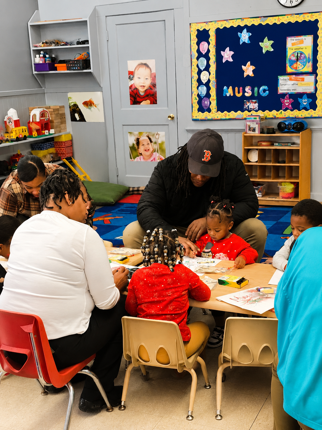 Children and teachers working together at a classroom table